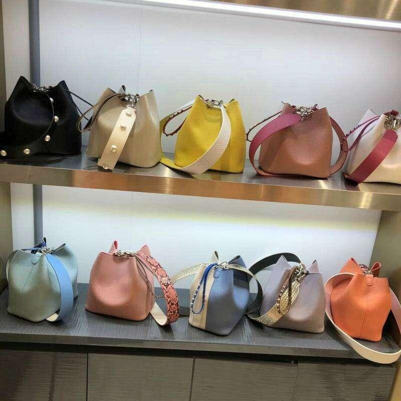Small bucket bag with a uniquely designed shoulder strap