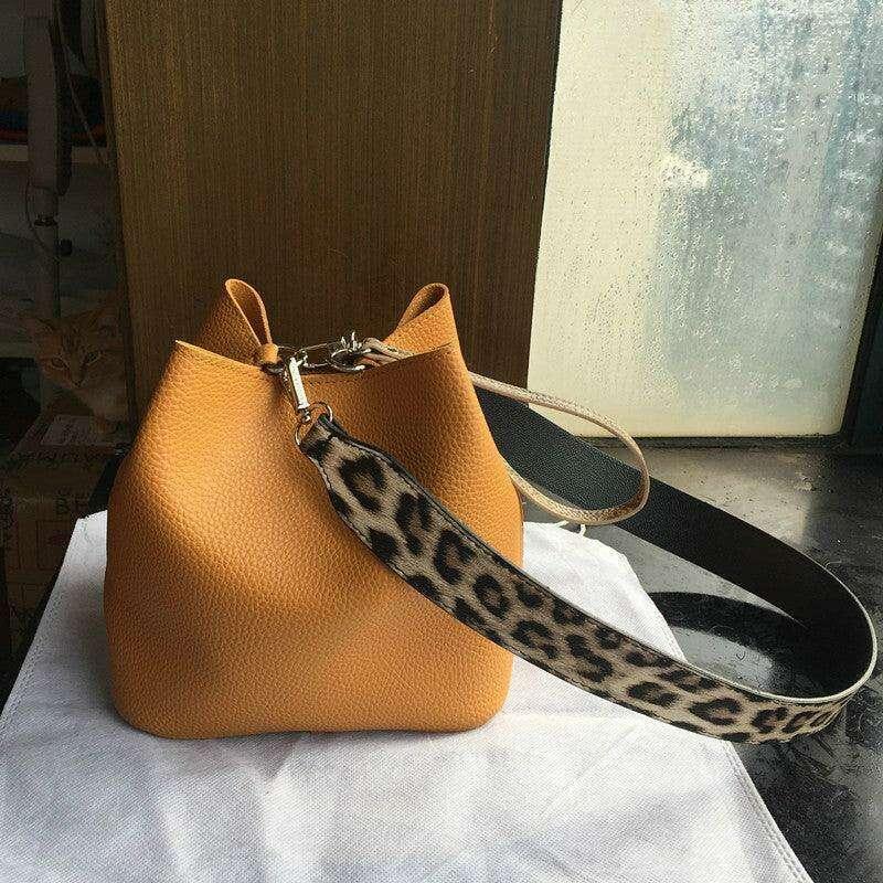 Small bucket bag with a uniquely designed shoulder strap