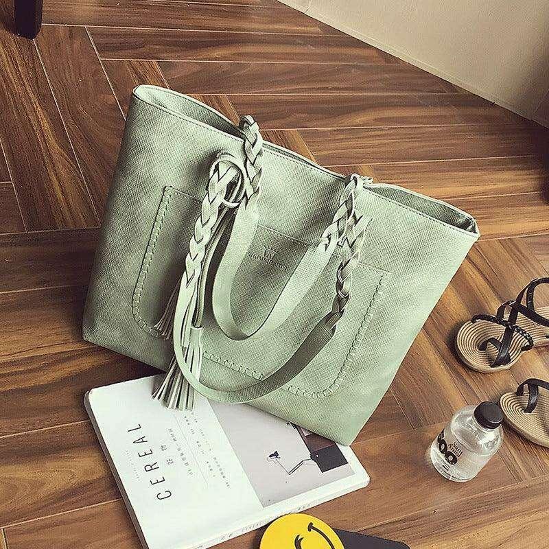Fashionable tote bag with braided and tassel decoration