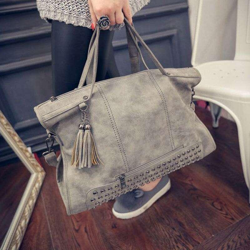 Gray crossbody bag with studs and fringes for women