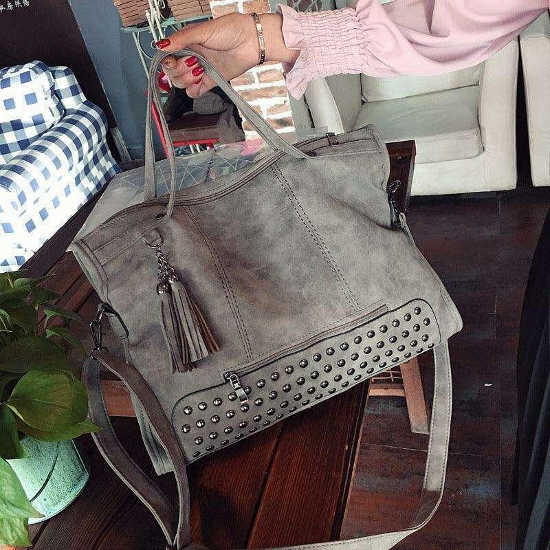 Gray crossbody bag with studs and fringes for women