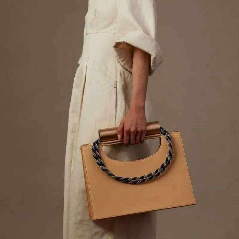 Elegant handbag with a unique handle for women