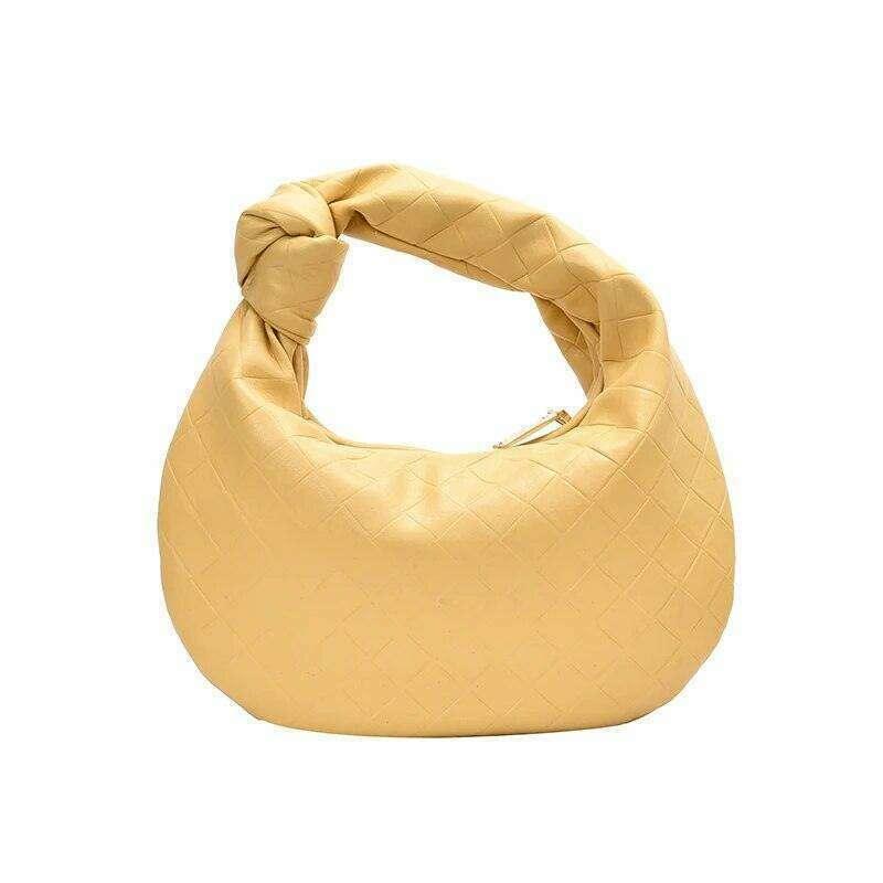 A fashionable bag in a round design with a delicate quilted texture.