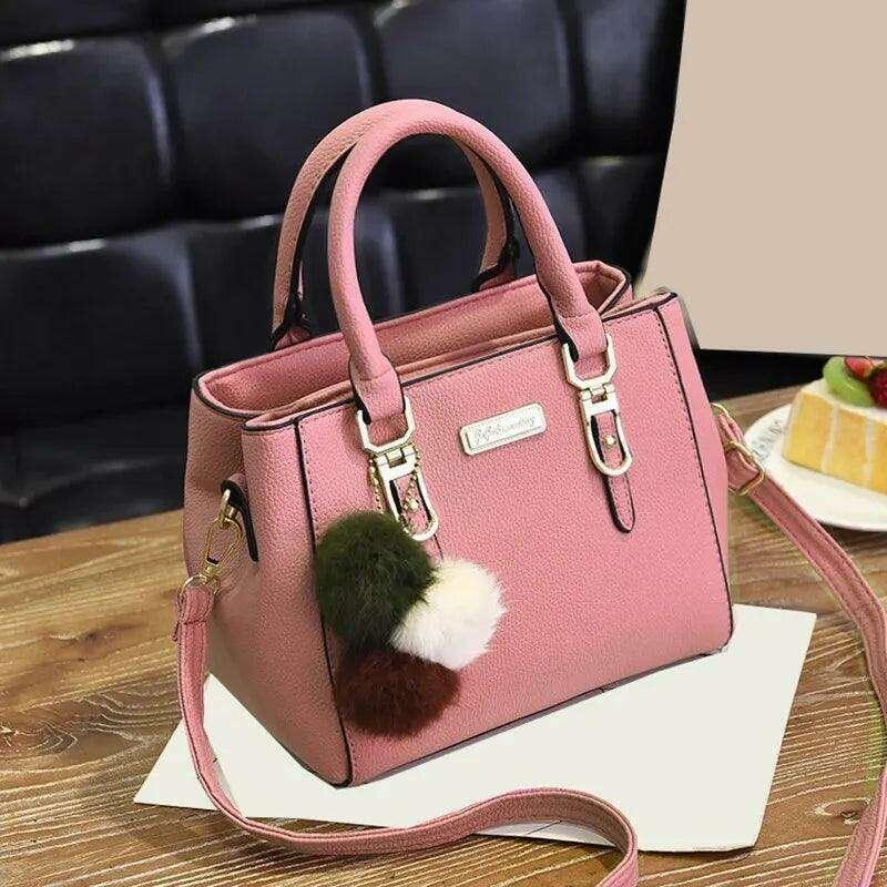 A fashionable handbag for women in a luxurious design with pom-pom accessories