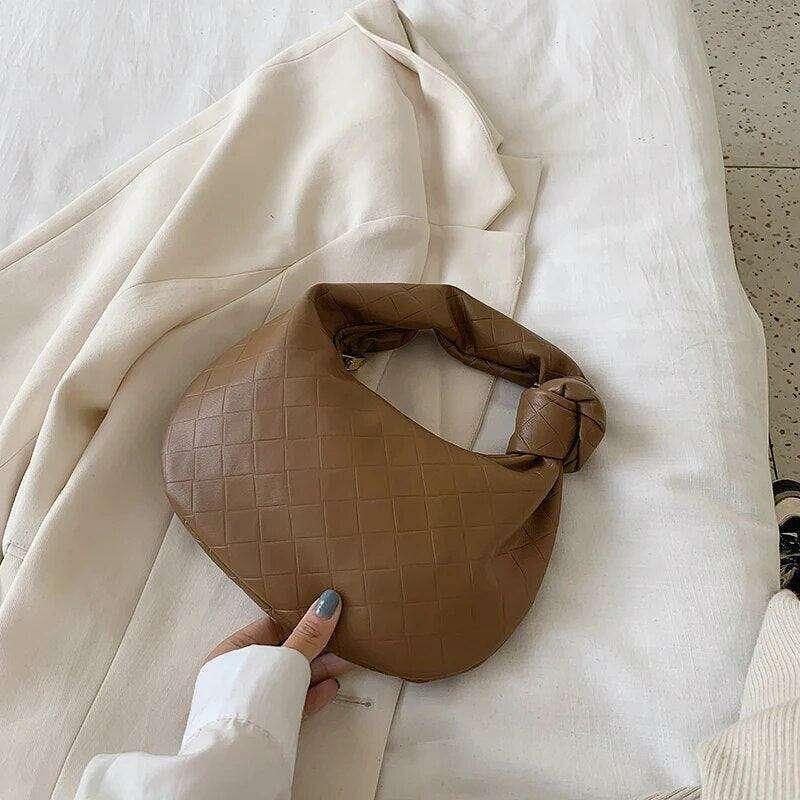 A fashionable bag in a round design with a delicate quilted texture.