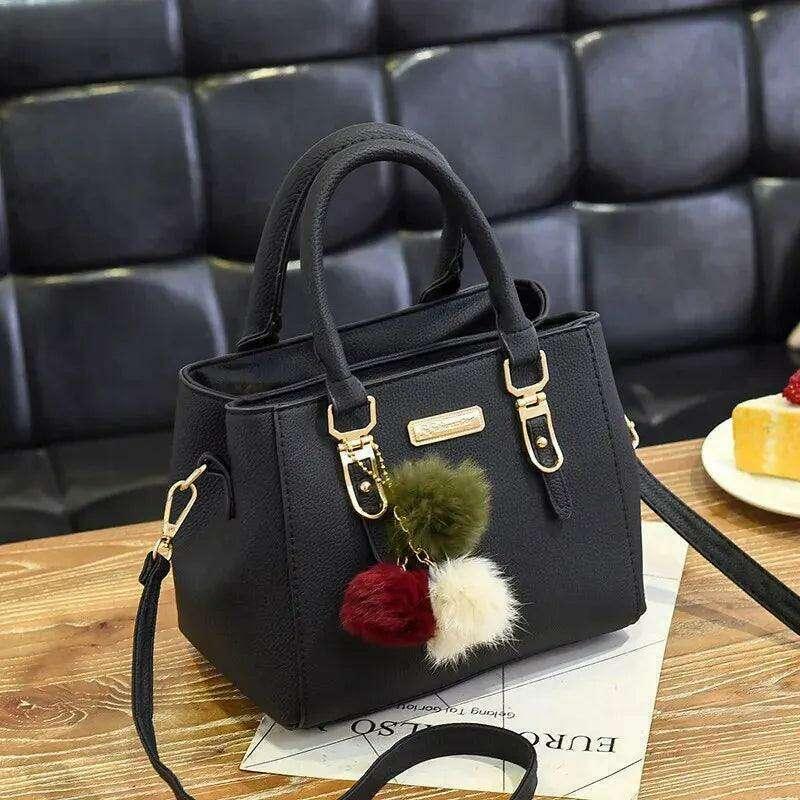 A fashionable handbag for women in a luxurious design with pom-pom accessories