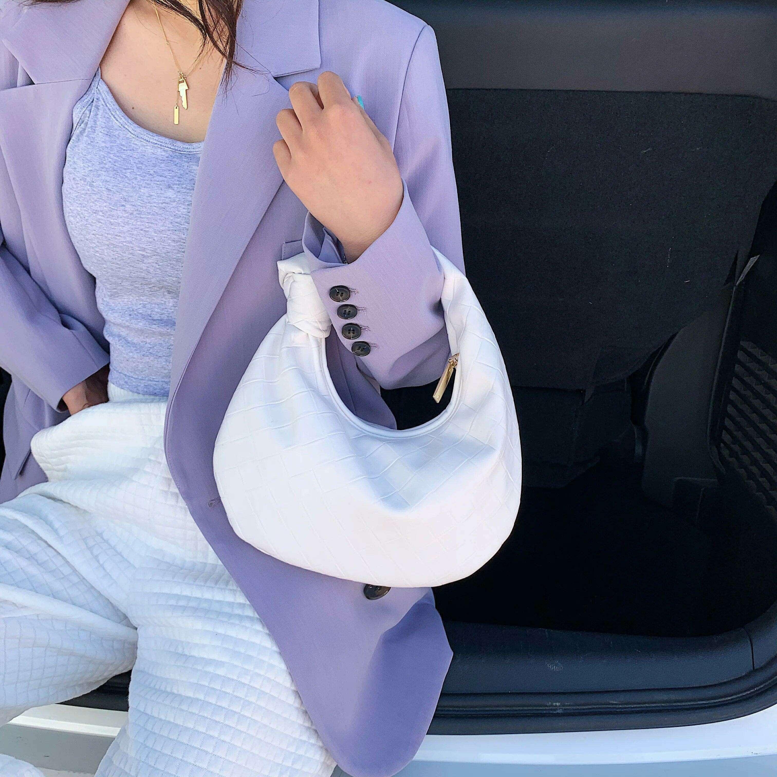 A fashionable bag in a round design with a delicate quilted texture.