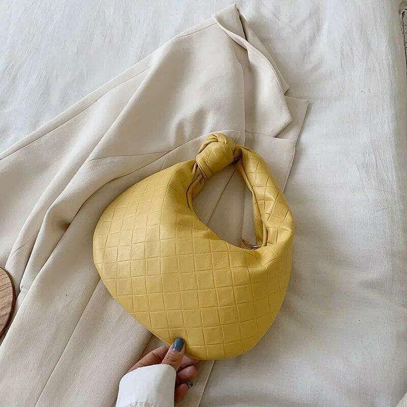 A fashionable bag in a round design with a delicate quilted texture.